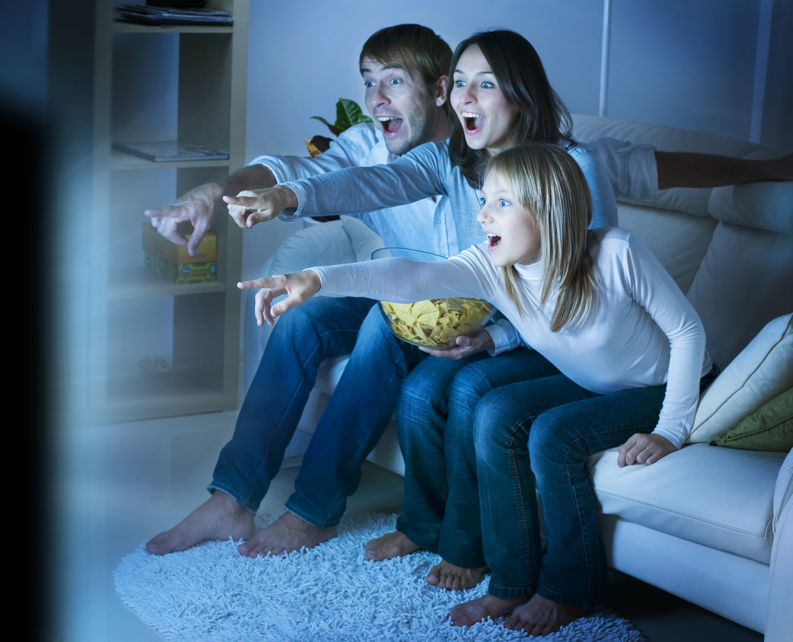 A family pointing at the TV